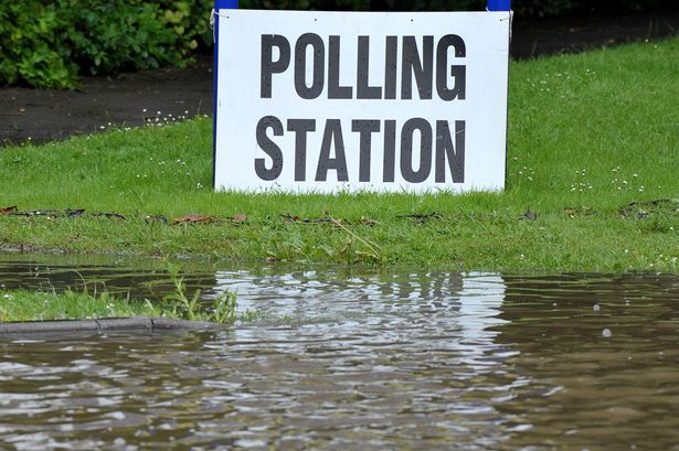 DEC23-A-polling-station-sign-sits-nest-to-a-flooded-path-at-a-polling-station-in-East-Hanningfield